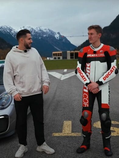 A view of Daniel Abt and a motorcyclist trying out a quarter-mile drag race between a Ducati Panigale V4 S and a Porsche GT2 RS