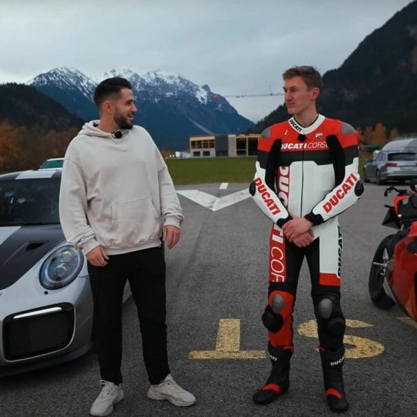 A view of Daniel Abt and a motorcyclist trying out a quarter-mile drag race between a Ducati Panigale V4 S and a Porsche GT2 RS