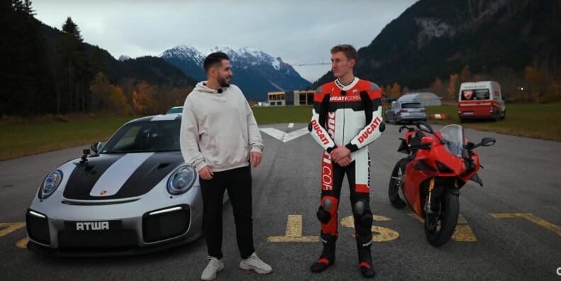 A view of Daniel Abt and a motorcyclist trying out a quarter-mile drag race between a Ducati Panigale V4 S and a Porsche GT2 RS