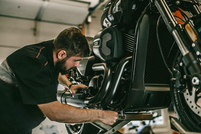 A view of a man working on a motorcycle build