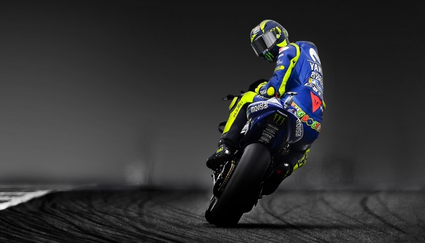 Valentino Rossi on his MotoGP bike prior to his retirement, looking over his shoulder