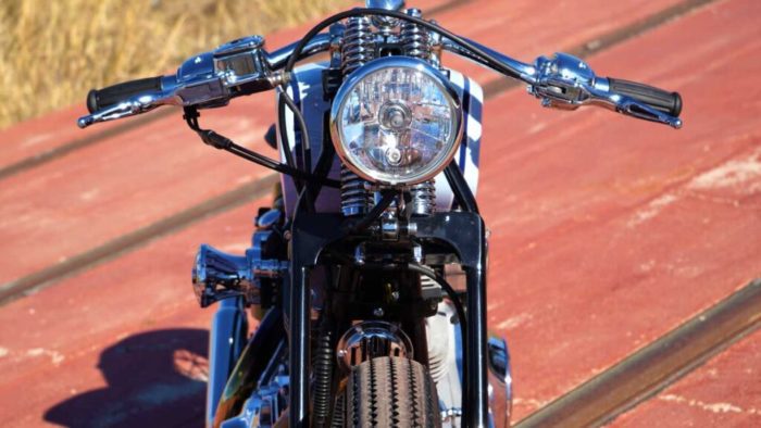 The headlight view from the custom Springer Bobber Blue Harley-Davidson Softail Standard Motorcycle from Lord Drake Kustoms