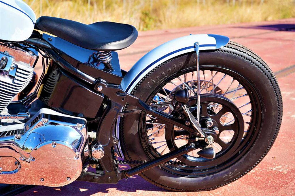 a left-side view of the rear wheel on the custom "Springer Bobber Blue" Harley-Davidson Softail Standard Motorcycle from Lord Drake Kustoms