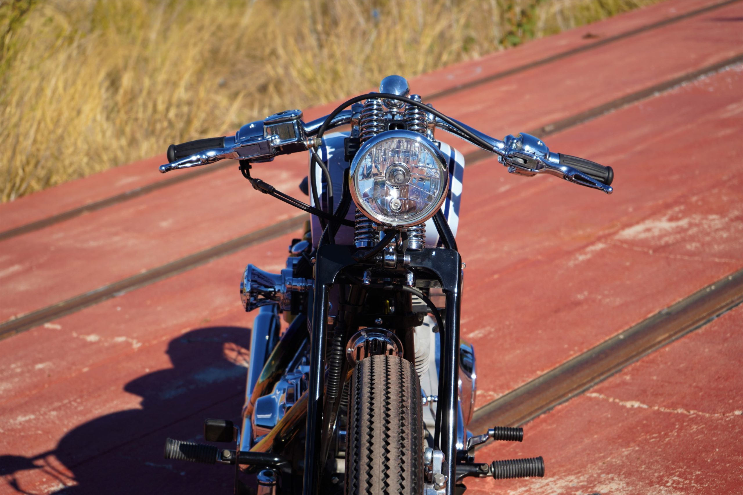 the front wheel view from the custom Springer Bobber Blue Harley-Davidson Softail Standard Motorcycle from Lord Drake Kustoms the front wheel view from the custom Springer Bobber Blue Harley-Davidson Softail Standard Motorcycle from Lord Drake Kustoms