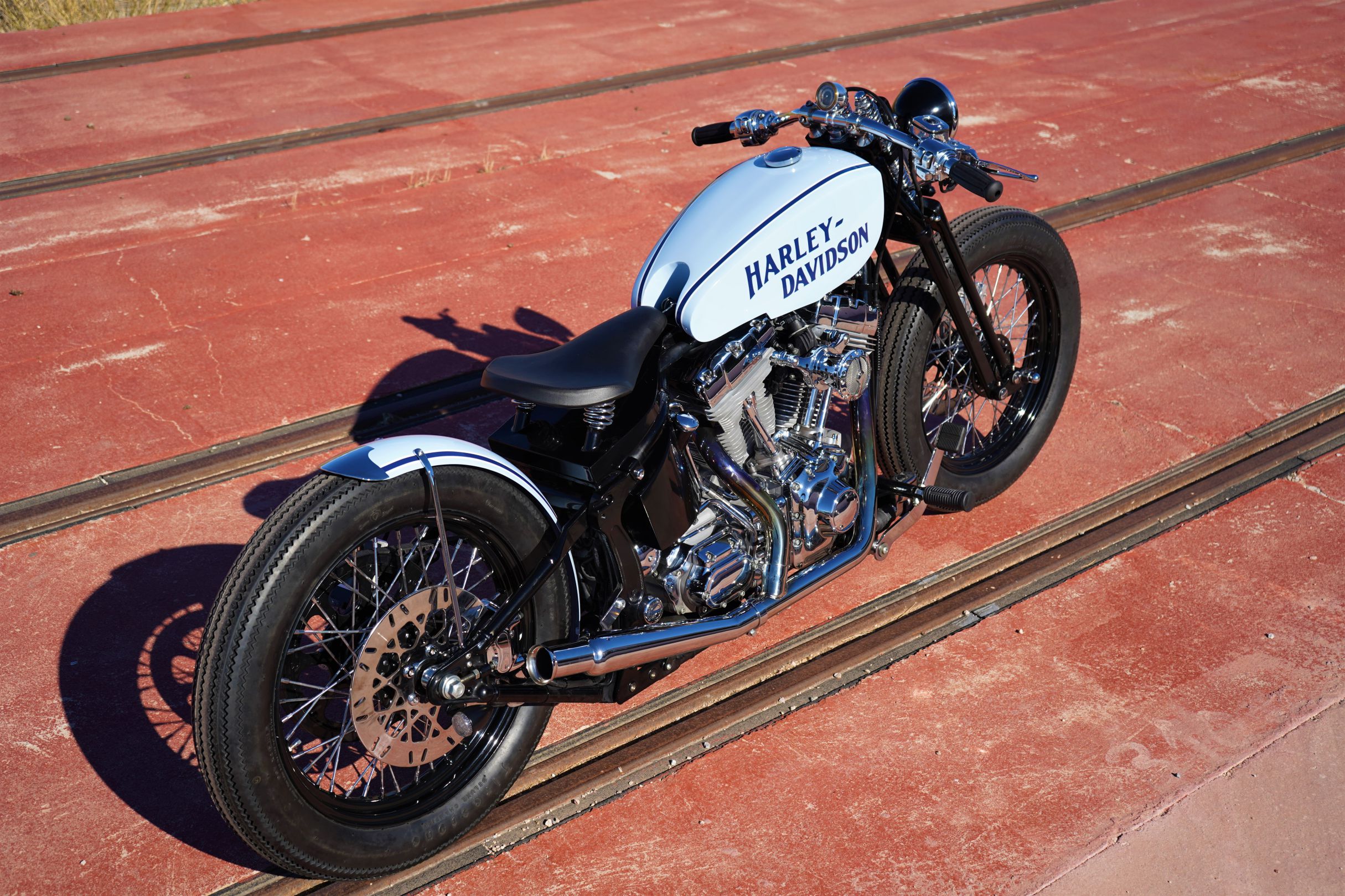 A rear-side view from the custom Springer Bobber Blue Harley-Davidson Softail Standard Motorcycle from Lord Drake Kustoms A rear-side view from the custom Springer Bobber Blue Harley-Davidson Softail Standard Motorcycle from Lord Drake Kustoms