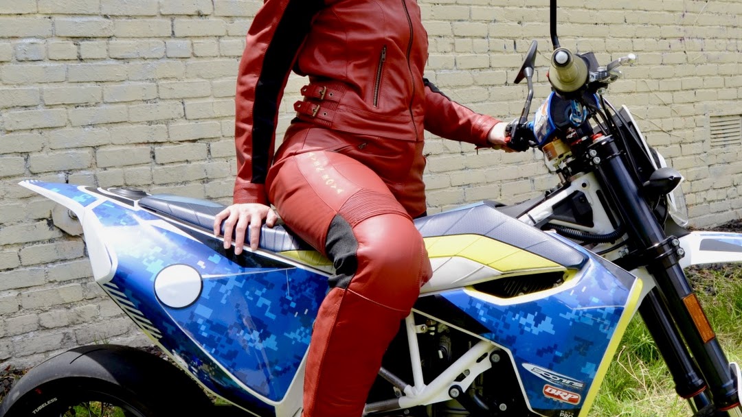 A view of Kathleen Eberle on her motorcycle, featuring the Raven Rova Phoenix jacket and pants.