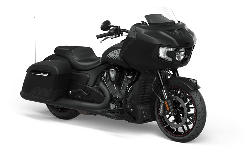 The 2022 Indian Motorcycle Challenger is what some would call a premium bagger—even more so than the Chieftain. What separates it from most of the other baggers is that this bike features a 1,768cc (or 108 cubic inch) PowerPlus V-twin that uses liquid cooling, as it provides a meaty 122 HP and 128 lb-ft of torque, at a basement-low 3,800 RPM. This allows the bike to not only have bar fairings, but body fairings as well, making it one of the most aerodynamic baggers out there today. Like the Chieftain, hidden in that bar fairing is a 7 inch touchscreen, Ride Command, and a 100 Watt audio system. LED lights all around bring that modern touch all premium bikes should have, and the suspension under the bar fairing with the headlight has a pillowy 130 mm of travel, smoothing out even the roughest road. Forward controls and relaxed, pulled-back bars join with one of the most cushioned seats ever to cradle your posterior on a bagger, giving you a motorcycle that was meant to take you not just from city to city, but from state to state, especially with its generous 6 US gallon tank. The Challenger is all about riding in luxurious comfort. MSRP: $23,999 USA / $29,249 CAN Learn More: IndianMotorcycle.com 2022 Indian Challenger Dark Horse