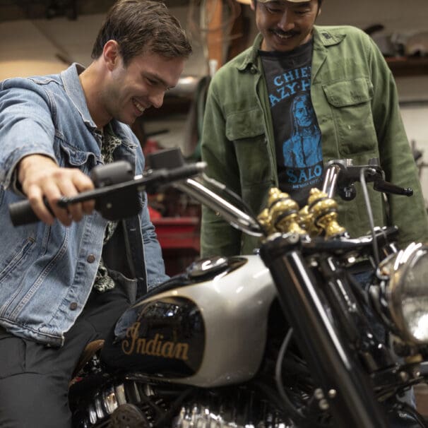 Gō Takamine with Nicolas Hoult next to the new Brat Style bobber from Inaidn Motorcycles that Takamine modded out for the movie star