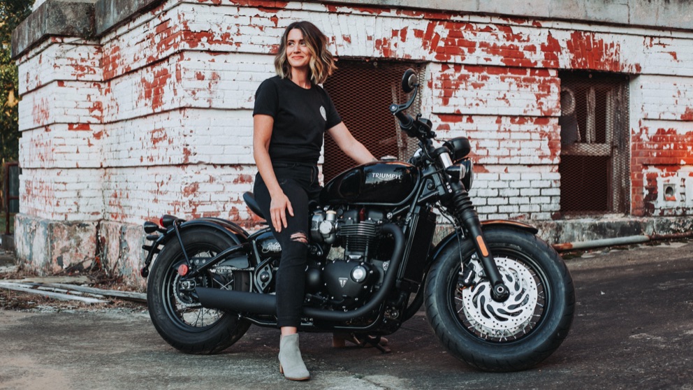 A woman enjoying her Triumph motorcycle