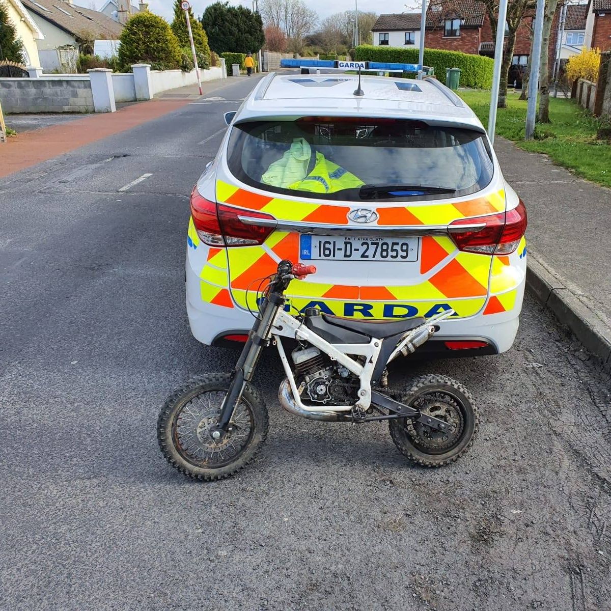 A view of a police car after having apprehended a scrambler from some Irish youth