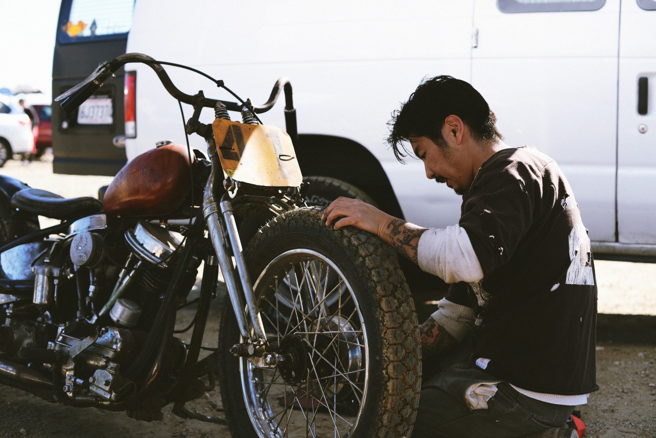 A view of Gō Takamine, founder of Brat Style, working on a bike