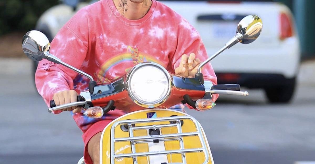 A view of Bieber riding his scooter