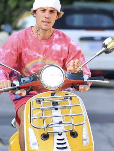 A view of Bieber riding his scooter