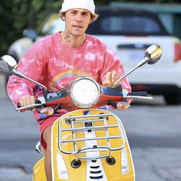 A view of Bieber riding his scooter