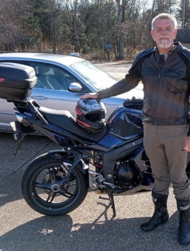 Author standing next to blue Triumph Sprint 1050