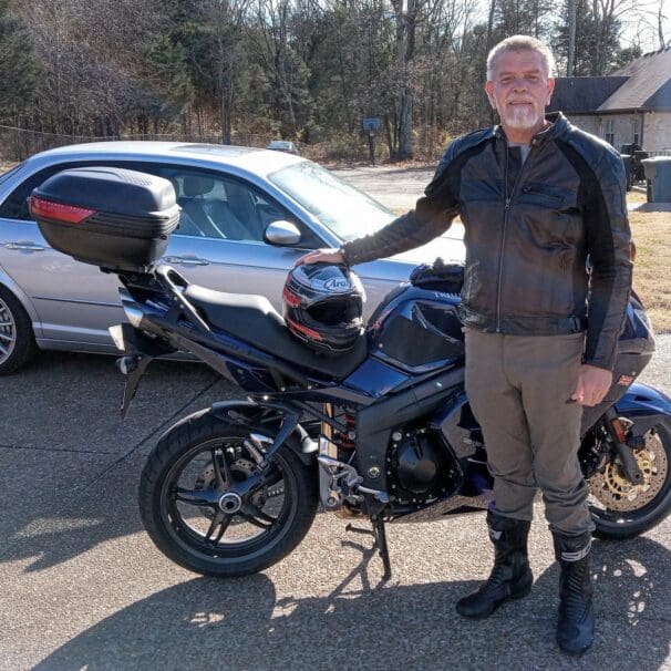 Author standing next to blue Triumph Sprint 1050