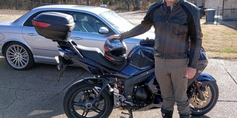 Author standing next to blue Triumph Sprint 1050