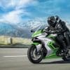 A view of a motorcyclist enjoying a ride with mountains in the background