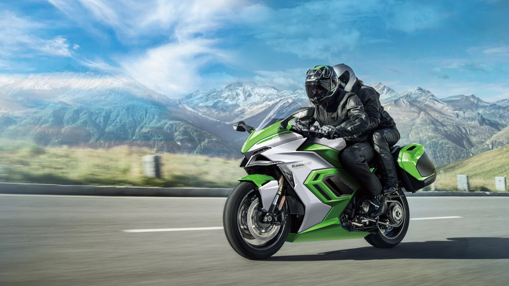 A view of a motorcyclist enjoying a ride with mountains in the background