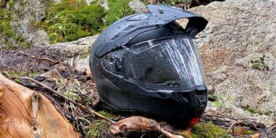 Quin Quest Smart Helmet sitting on mossy rock in forest