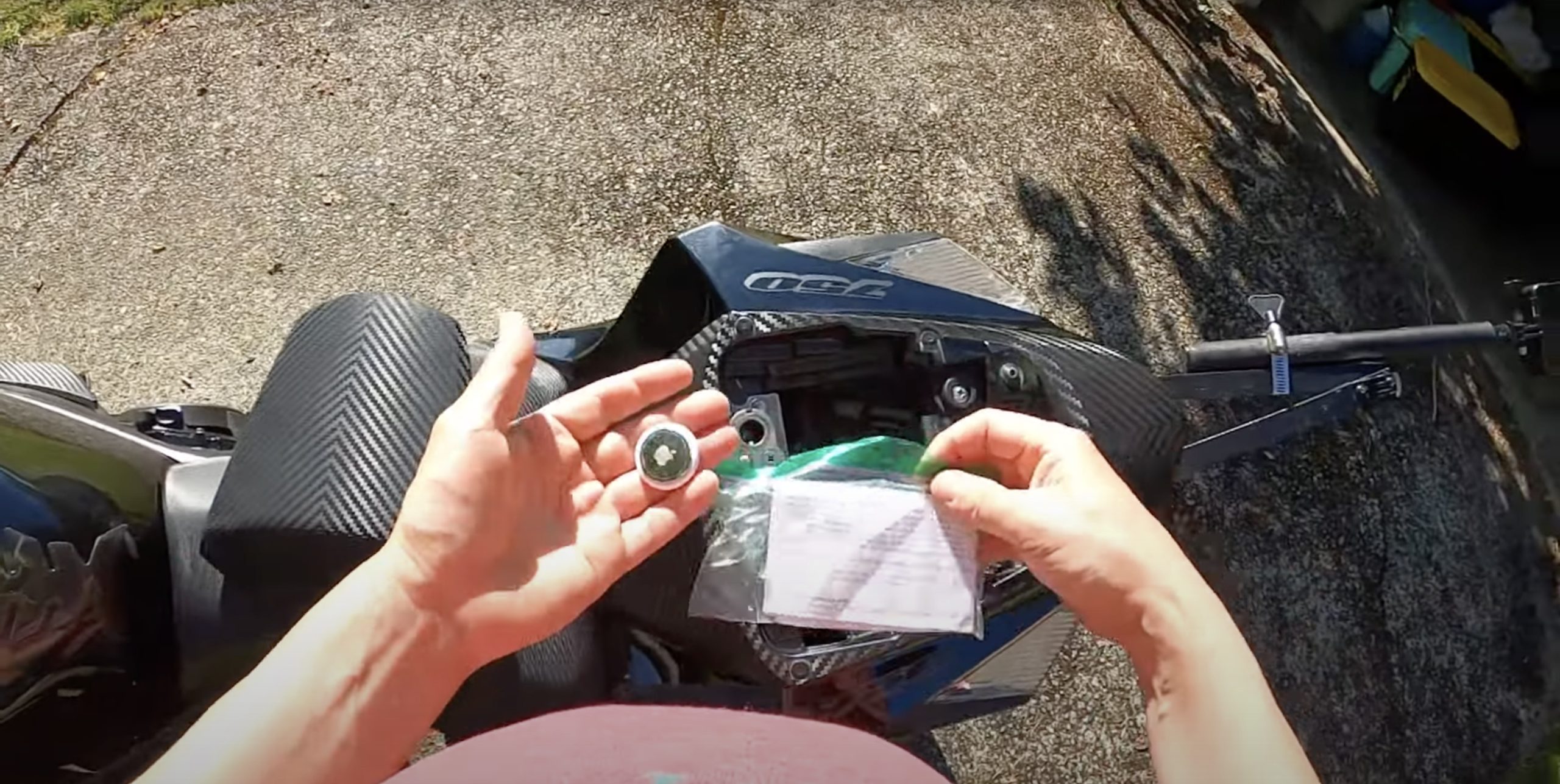 A view of an Apple AirTag next to a motorcycle