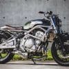 A 2006 Kawasaki ER-6F that's been tricked out with a retro, cafe racer flair