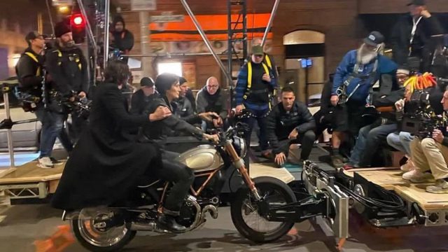 A view of Reeves and Carrie-Anne trying out a Ducati bike for the Matrix