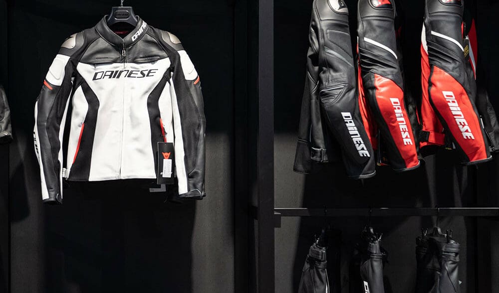 A view of several Dainese motorcycle suits on the rack at a store