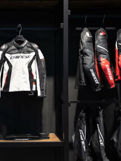 A view of several Dainese motorcycle suits on the rack at a store