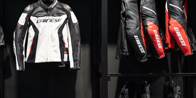 A view of several Dainese motorcycle suits on the rack at a store