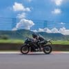 A view of a rider enjoying a lean into the twisties, on a Kawasaki motorcycle