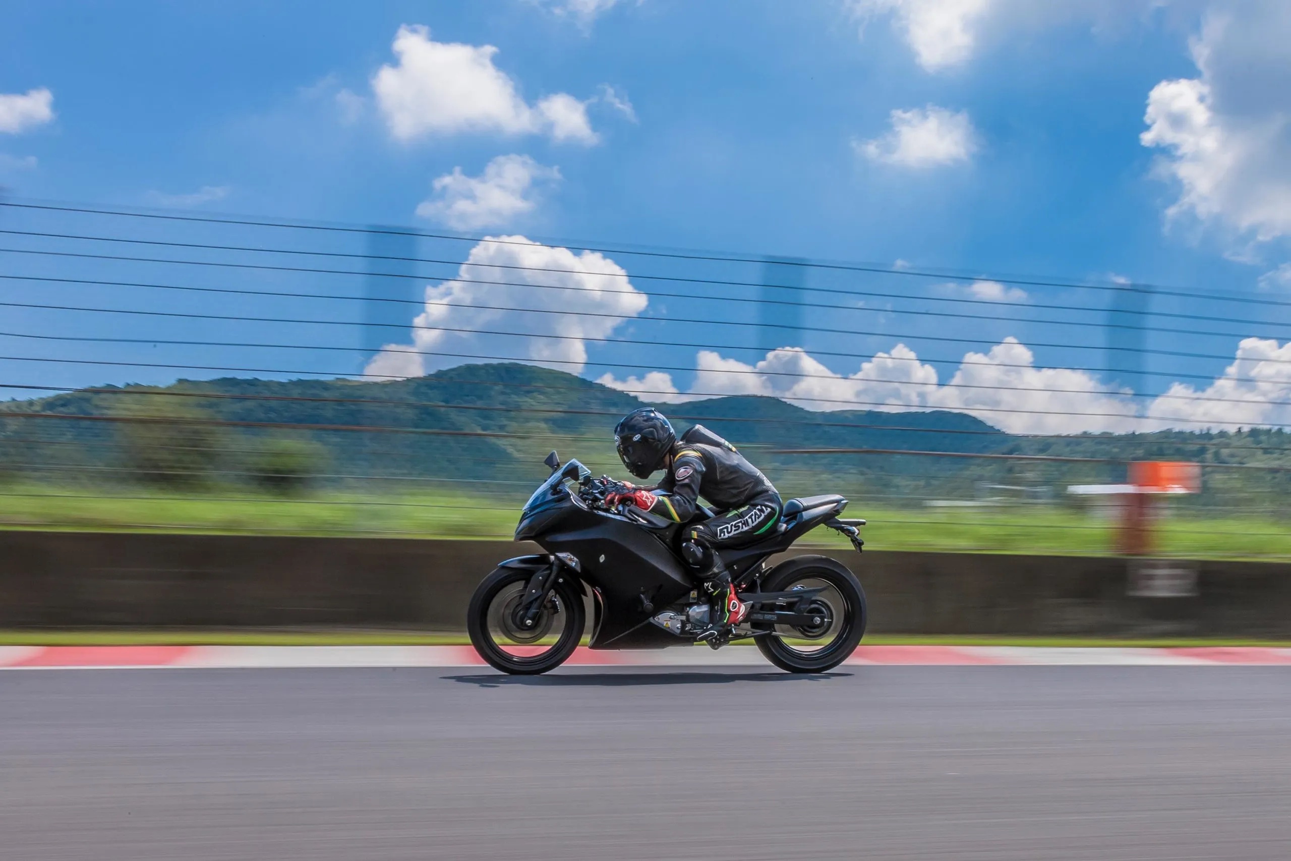 A view of a rider enjoying a lean into the twisties, on a Kawasaki motorcycle