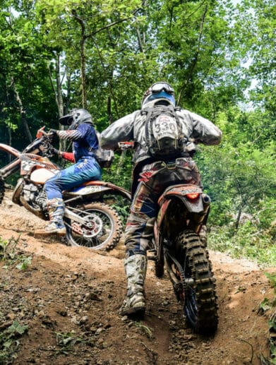 A view of a set of youngsters using a trail for scrambler riding