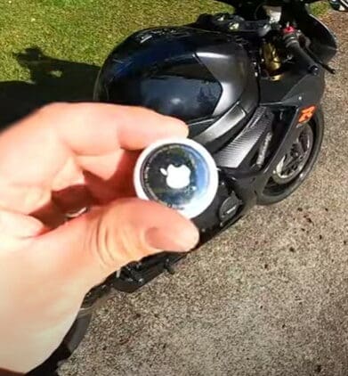 A view of an Apple AirTag next to a motorcycle