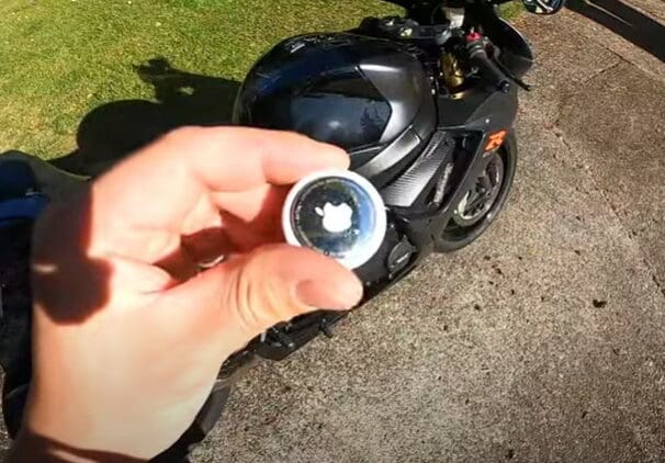 A view of an Apple AirTag next to a motorcycle