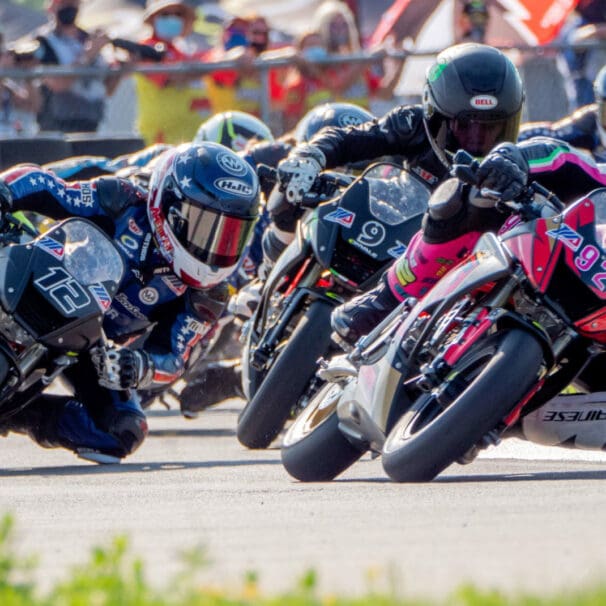 A view of MiniGP riders in the race to win the cup and continue forward in the pursuit toward MotoGP