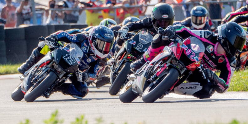 A view of MiniGP riders in the race to win the cup and continue forward in the pursuit toward MotoGP