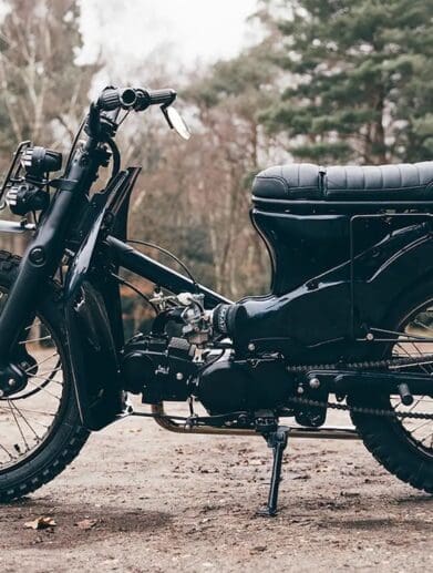 A view of a custom Honda Super Cub that has been customized by Scar's Motorcycles
