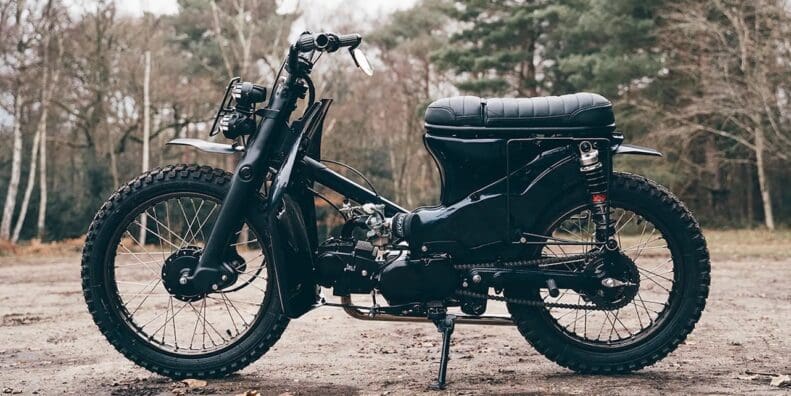 A view of a custom Honda Super Cub that has been customized by Scar's Motorcycles