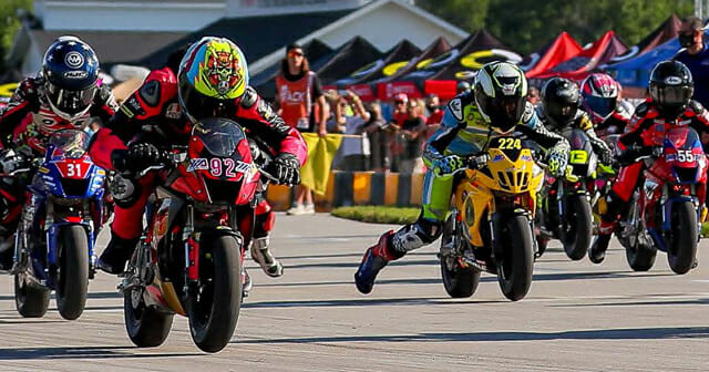 A view of MiniGP riders in the race to win the cup and continue forward in the pursuit toward MotoGP