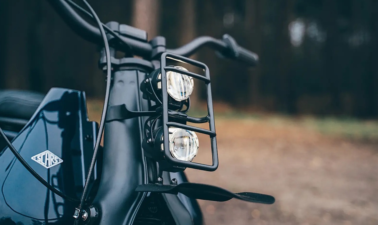 A view of a custom Honda Super Cub that has been customized by Scar's Motorcycles