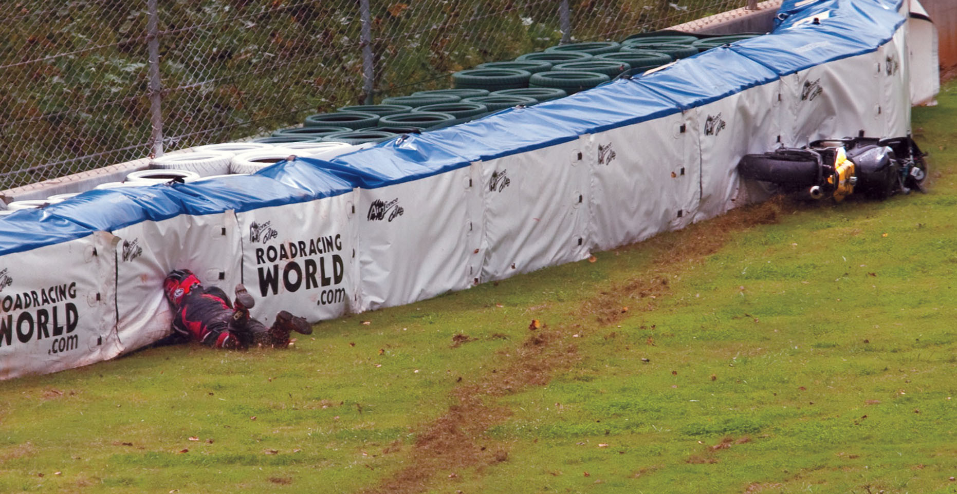 A view of the racers at MotoAmerica using the flimsy soft barriers for motorcycle accidents