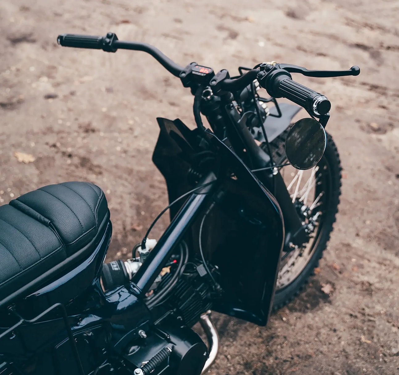 A view of a custom Honda Super Cub that has been customized by Scar's Motorcycles