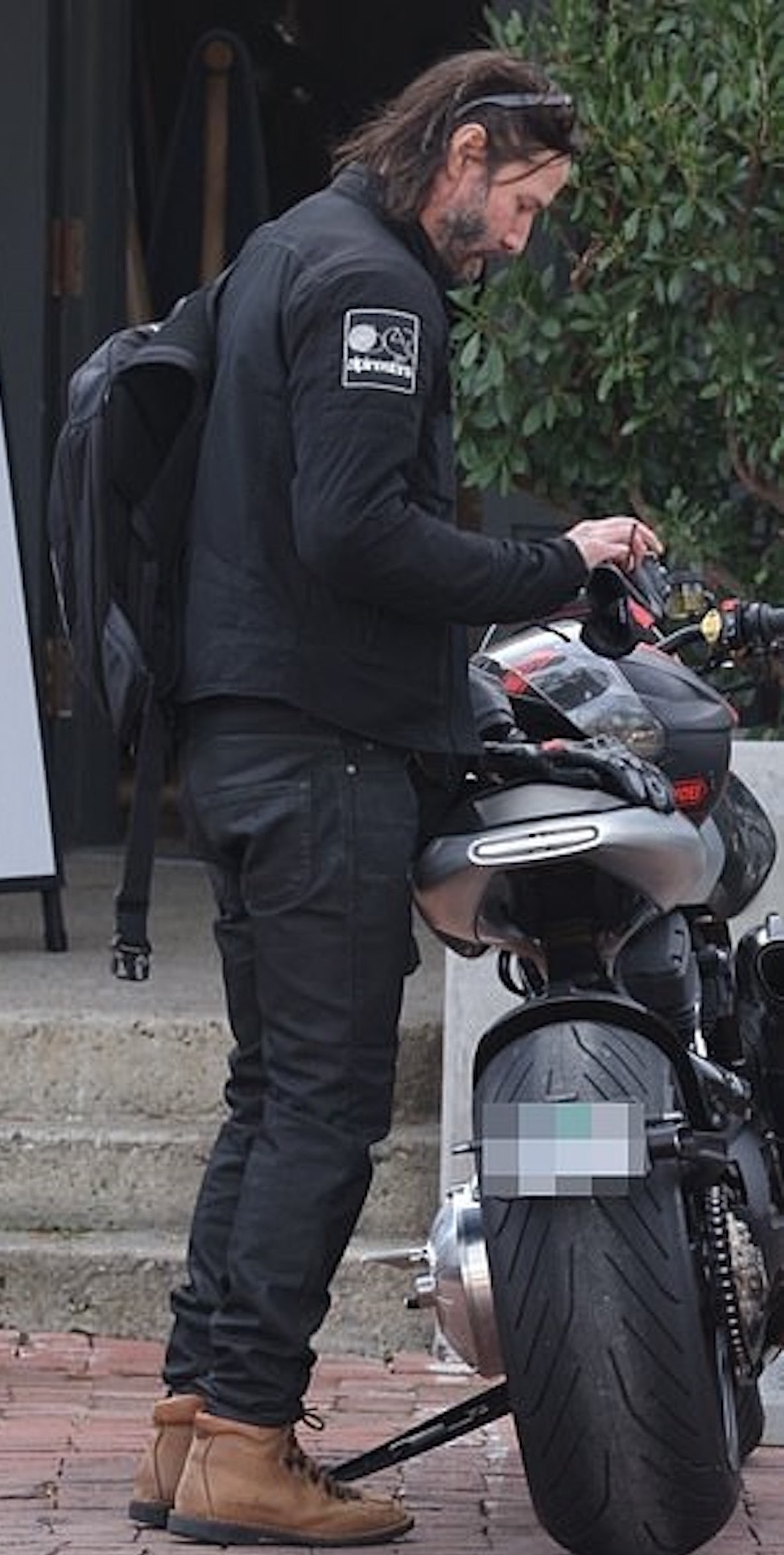 A view of Alex Winter and Keanu Reeves meeting for a cup of coffee on two arch motorcycles