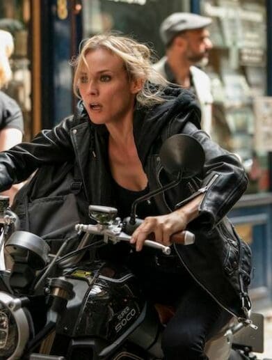 A character from the movie 'The 355' rides on a super solo TC Max