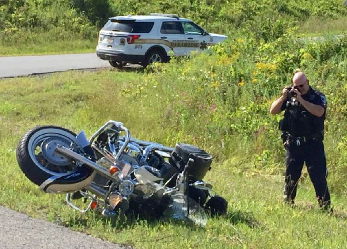 police taking a picture of a motorcycle accident