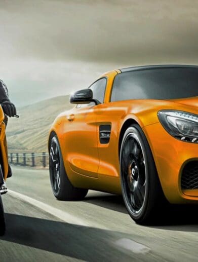 A view of a motorcyclist and a car