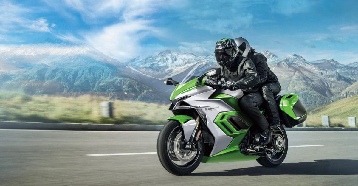 A view of a Kawasaki rider riding beyond a scope of mountains