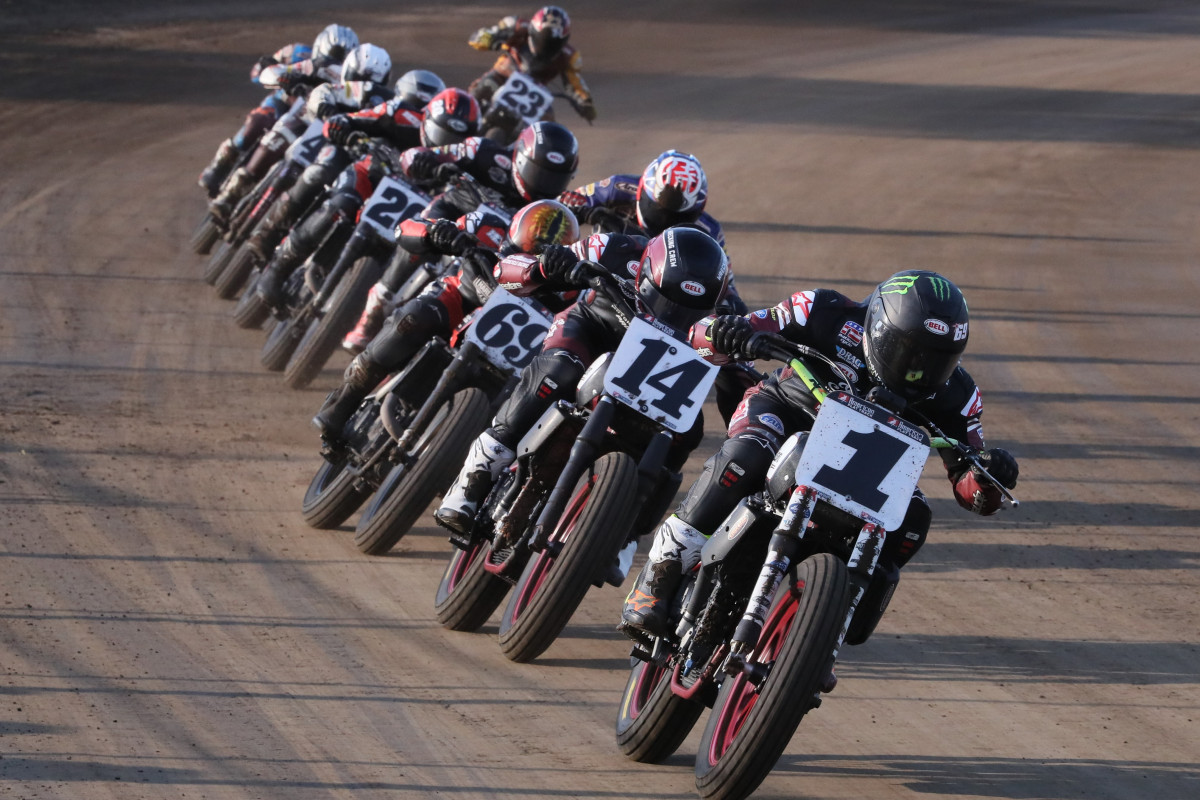 a view of American flat track racers leaning into the twisties