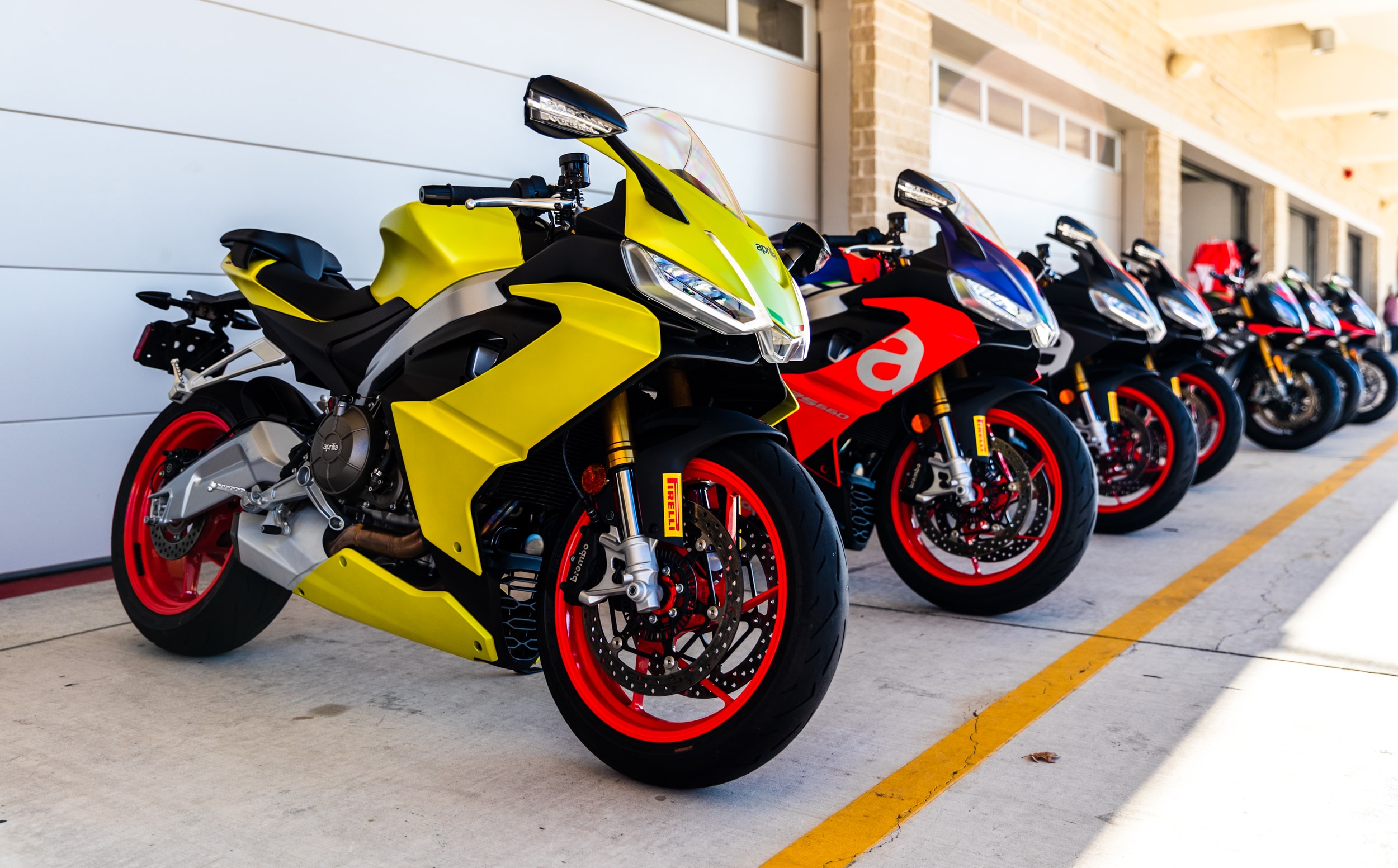 A view of the Aprilia Racer Days that will be happening between May and October of this year, with scads of chances to rub shoulders with racing icons, as well as try out the latest from Dainese, AGV, Pirelli and Aprilia's sport bike lineup.